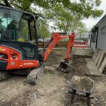 Mini excavator and wheelbarrows during Slice of Hope excavation