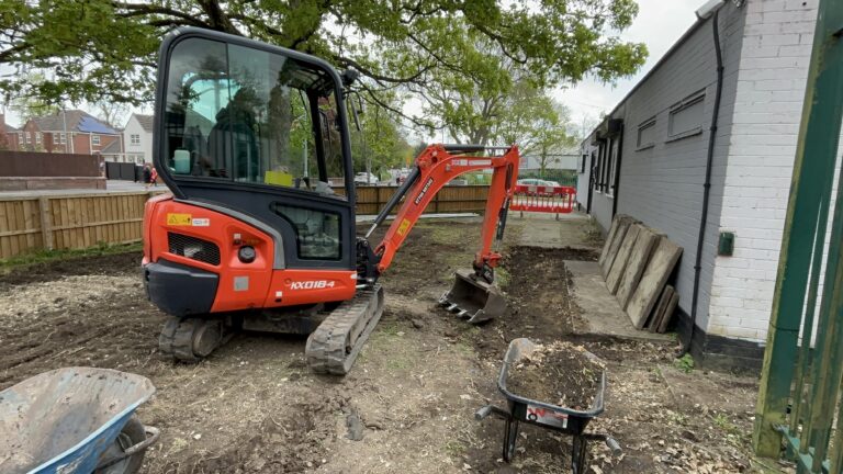Mini excavator and wheelbarrows during Slice of Hope excavation