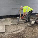 Laying paving slabs for outdoor space at Slice of Hope